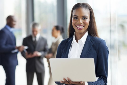 Business women smiling with laptop