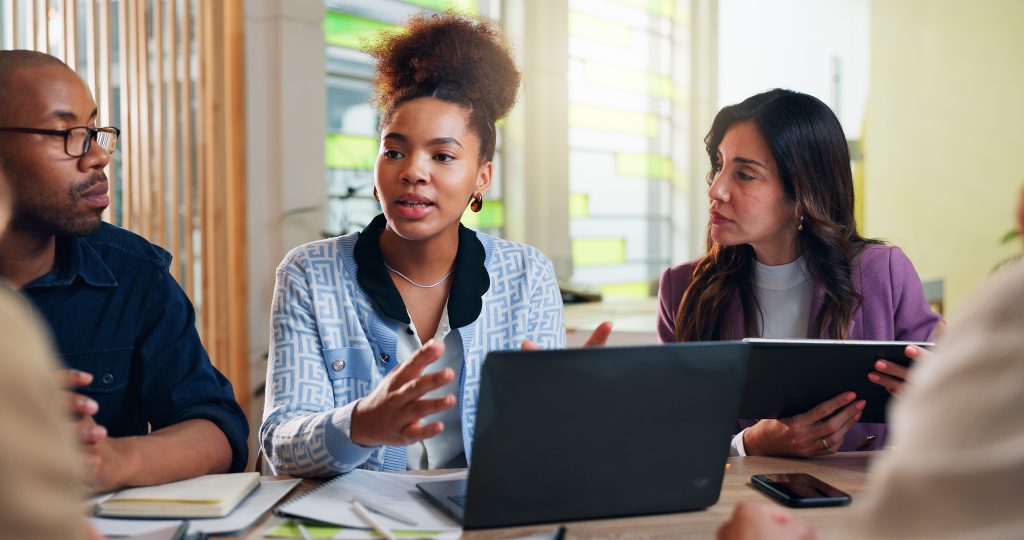 Business people in a meeting or discussion with a laptop.